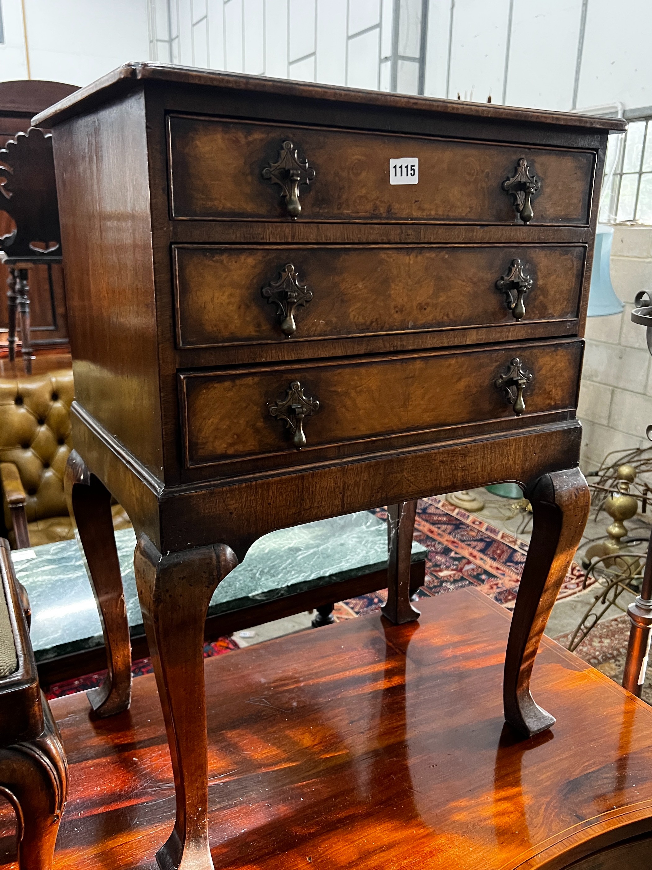 A George III style walnut bedside chest, fitted three long drawers, width 53cm, depth 39cm, height 75cm